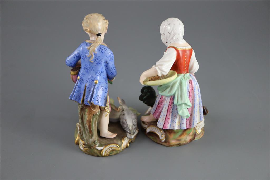 A pair of Meissen figures after the 18th century models of children feeding geese and chickens, 19th century, 12cm and 13cm high